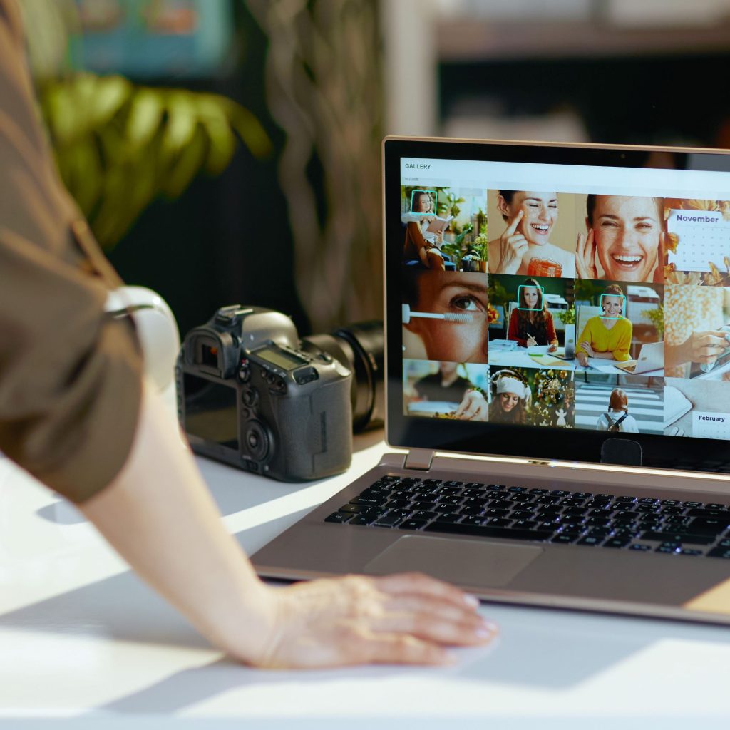 Woman looking at a gallery of photos on a computer screen.